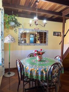 a dining room table with a vase of flowers on it at Apartamento in Barra del Chuy