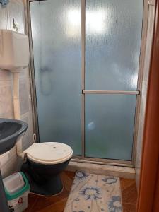 a bathroom with a shower with a toilet and a sink at Apartamento in Barra del Chuy