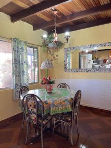a dining room with a table and chairs and a mirror at Apartamento in Barra del Chuy +5 photos