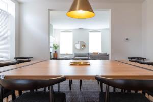 a dining room with a large wooden table and chairs at Spacious Haven near Busch ABODEbucks in Soulard