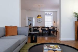 a living room with a couch and a table at Spacious Haven near Busch ABODEbucks in Soulard