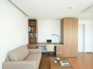 a living room with a couch and a desk at Residence Hotel K Okpo in Geoje +37 photos