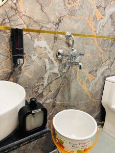 a bathroom with a sink and a bowl on a counter at Hotel Shri Ji Palace in Haridwār +65 photos
