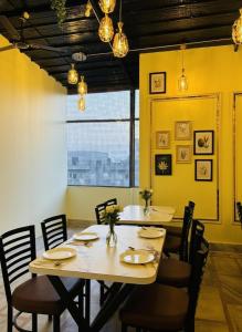 a dining room with a wooden table and chairs at Hotel Shri Ji Palace in Haridwār