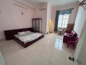 a bedroom with a bed and a chair and a window at Homestay 846/B53 in Vung Tau +27 photos