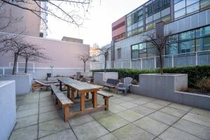 a patio with a table and benches in front of a building at Casa DT Vancouver - Mexican Theme in Vancouver