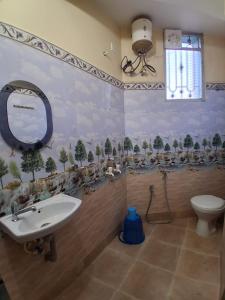 a bathroom with a sink and a toilet at Bhakta Bhawan in mayapur +69 photos