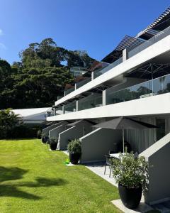 an external view of a building with a lawn at 71 Hastings - Beachfront in Noosa Heads