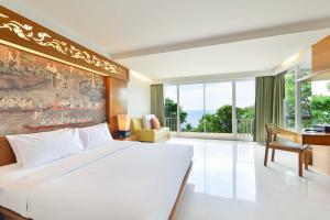a bedroom with a large bed and a large window at SYLVAN Koh Chang in Ko Chang
