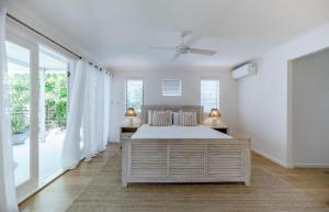 a white bedroom with a bed and a large window at Luxe Beach House at Sunshine in Sunshine Beach +52 photos