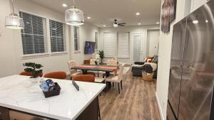 a kitchen and living room with a table and chairs at 5 mins to NRG and The Medical Center The Houston Reston in Houston