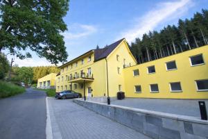 a yellow building with a car parked in front of it at The Meetinka - Peaceful Stay, Jeseníky in Jeseník