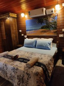 a bedroom with two beds and a painting on the wall at Jasmine Beach Resort in Morjim +82 photos