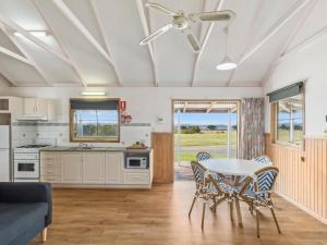 a kitchen and dining room with a table and chairs at Batemans Bay Marina Resort in Batemans Bay