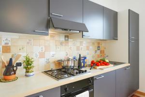 a kitchen with a stove and a counter top at Villa L'Approdo in Porlezza