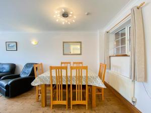 a dining room with a table and chairs at Sweet Coppin in Ledbury