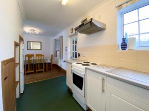 a kitchen with a stove top oven next to a window at Sweet Coppin in Ledbury