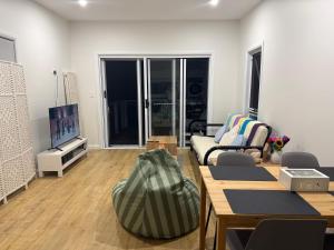 a living room with a couch and a tv at Cosy Granny flat in Epping in Epping
