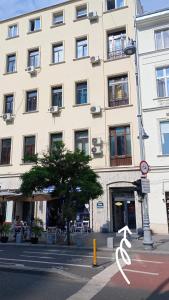 a large white building on a city street at Victoriei54YOU in Bucharest