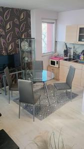 a kitchen with a glass table and chairs at Кичук Париж in Plovdiv