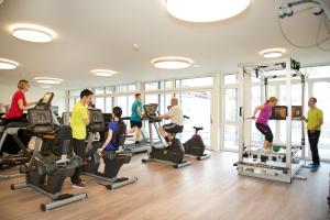a group of people exercising in a gym at Hotel Artos Interlaken in Interlaken