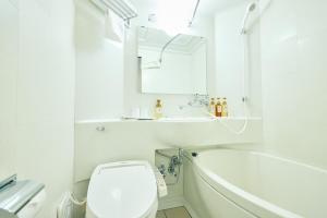 a bathroom with a tub and a toilet and a sink at Urbain Hiroshima Executive in Hiroshima +11 photos
