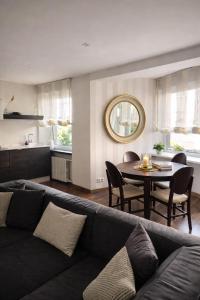 a living room with a couch and a table at Downtown Boulevard View Residence in Šiauliai