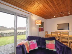 a living room with a couch and a table at Inshcraig in Kincraig
