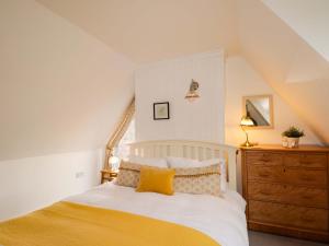 a bedroom with a bed and a wooden dresser at Inshcraig in Kincraig