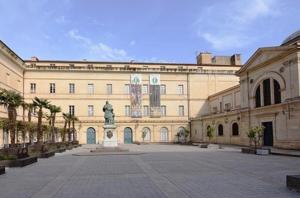 a large building with a statue in front of it at Appartement premium Hyper Centre in Ajaccio