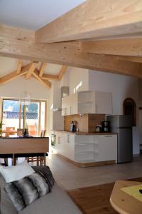 a kitchen with wooden ceilings and a table in a room at Privatpension Bergkristall in San Martino