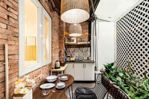 a patio with a table and chairs and a kitchen at StayX Central Suites Q1 in Ho Chi Minh City