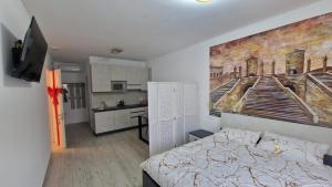 a room with a bed and a painting on the wall at Salicornia Rooms in Comacchio