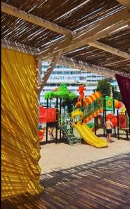 a playground with a slide and a play structure at DIANA Seaside Holiday in Olimp