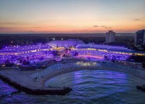 a group of buildings lit up at night at DIANA Seaside Holiday in Olimp