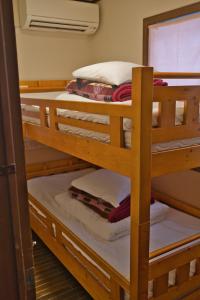 a couple of bunk beds in a room at IZA Kamakura Guest House and Bar in Kamakura
