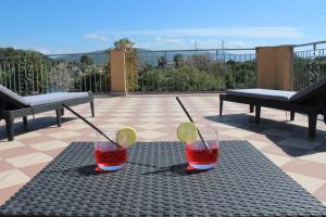 two glasses of drink on a table on a patio at Apartment - Pizzo Beach Club in Fondaco Vecchio