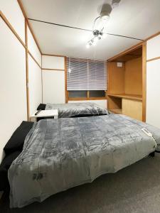 a bedroom with a large bed and a ceiling fan at 台町Arun別邸 in Abashiri +28 photos