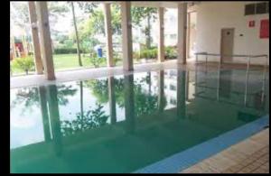 a pool of water in a building with a reflection in it at Puchong Permata Homestay 3BR in Puchong
