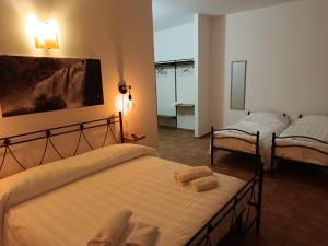 a hotel room with two beds and a mirror at Hotel Panorama in Cerreto di Spoleto +32 photos