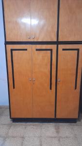 a wooden cabinet with two doors in a room at Habitacion en Casa de Olga in Alta Gracia