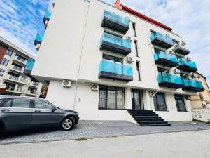 a car parked in front of a building at Amira Residence in Eforie Nord