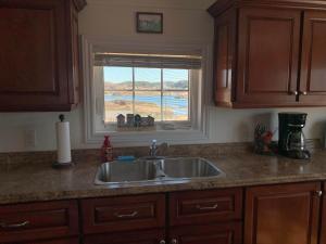 a kitchen counter with a sink and a window at Salty B'y Cottage in Twillingate