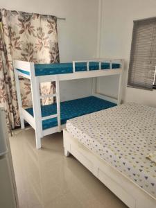 a bedroom with two bunk beds in a room at UB HOME in Dauis