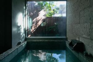 a pool of water in a room with a window at Minato-no Akari in Hayama