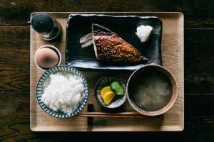 a tray of food with sushi and rice on a table at Minato-no Akari in Hayama