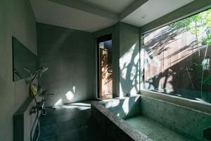 a bathroom with a shower and a window and a tub at Minato-no Akari in Hayama +41 photos