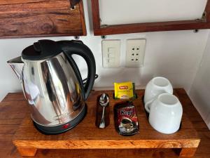 a coffeemaker on a wooden counter with a coffee pot at Toba Crest Vue in Parapat +48 photos