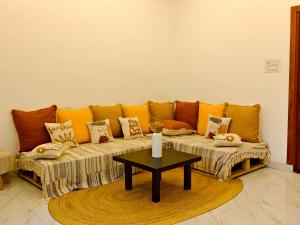a couch in a living room with a table at SAIR Hostel, Varanasi - 100m from Assi Ghat in Varanasi