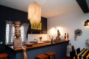 a kitchen with a counter with artifacts on it at Tiako Beach in Nosy Be